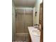 Bathroom with a glass-enclosed shower, cream-colored sink, and tiled floors at 5862 Sw 160Th Ct, Ocala, FL 34481