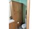 This bathroom has ample cabinet space, a toilet, and modern flooring at 5862 Sw 160Th Ct, Ocala, FL 34481