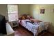 A cozy bedroom with a comfortable bed and wooden floors at 5862 Sw 160Th Ct, Ocala, FL 34481