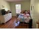 A cozy bedroom with a comfortable bed and wooden floors at 5862 Sw 160Th Ct, Ocala, FL 34481