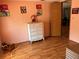 View of bedroom featuring wood-look flooring, dresser, and doorway at 5862 Sw 160Th Ct, Ocala, FL 34481