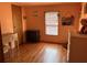 Bedroom featuring warm-toned walls, wood-look flooring, and a window with blinds at 5862 Sw 160Th Ct, Ocala, FL 34481