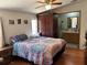 Cozy bedroom featuring a colorful bedspread, ceiling fan, and an ensuite bathroom at 5862 Sw 160Th Ct, Ocala, FL 34481