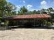 Open-sided carport structure with rusting metal roof at 5862 Sw 160Th Ct, Ocala, FL 34481