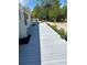 Mobile home side entry, featuring a long, covered deck at 5862 Sw 160Th Ct, Ocala, FL 34481