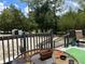 View of a deck with a table and chairs and view of yard with trees at 5862 Sw 160Th Ct, Ocala, FL 34481