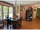 Dining room area with large windows and rustic table at 5862 Sw 160Th Ct, Ocala, FL 34481