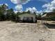 Exterior shot of the home shows a deck and a gravel-covered yard at 5862 Sw 160Th Ct, Ocala, FL 34481