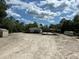 Exterior view of property with residence, carports and sheds at 5862 Sw 160Th Ct, Ocala, FL 34481