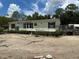 Inviting single-story home with a well-maintained exterior, charming shutters, and a lush green surroundings at 5862 Sw 160Th Ct, Ocala, FL 34481