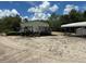 Home featuring a wooden deck and stairs, open carport and gravel area at 5862 Sw 160Th Ct, Ocala, FL 34481