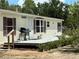 Side view showcasing the deck with a grill, ideal for summer barbecues and enjoying the outdoors at 5862 Sw 160Th Ct, Ocala, FL 34481
