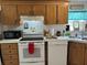 Features classic white appliances and oak cabinets for a warm, inviting feel at 5862 Sw 160Th Ct, Ocala, FL 34481