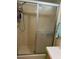 Bathroom shower with sliding glass doors and chrome fixtures at 5862 Sw 160Th Ct, Ocala, FL 34481
