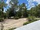 Looking out at a gravel area with a tree border at 5862 Sw 160Th Ct, Ocala, FL 34481