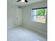 Bedroom featuring marble floors and a large window at 6475 Nw 61St Ave, Ocala, FL 34482
