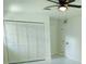 Bedroom featuring a ceiling fan, a closet, and new white and gray tile flooring at 6475 Nw 61St Ave, Ocala, FL 34482