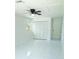 Bright bedroom featuring a ceiling fan, a window, a closet, and new white and gray tile flooring at 6475 Nw 61St Ave, Ocala, FL 34482