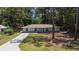 Charming light blue single-story home with well-manicured front yard and long driveway at 6475 Nw 61St Ave, Ocala, FL 34482