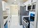 Modern kitchen with stainless steel appliances, granite countertops, and white cabinets at 6475 Nw 61St Ave, Ocala, FL 34482