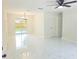 Bright living room featuring tile floors, new ceiling fan, neutral paint, and access to back yard at 6475 Nw 61St Ave, Ocala, FL 34482