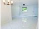 Spacious living room featuring modern light fixture, fan, and marble floors at 6475 Nw 61St Ave, Ocala, FL 34482