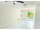 Bright living room boasts marble floors, fan, and natural light through sliding glass doors to a fenced yard at 6475 Nw 61St Ave, Ocala, FL 34482