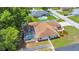 Aerial view of the property featuring a screened-in pool and lush landscaping at 6631 Se 11Th Loop, Ocala, FL 34472