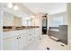 Well-lit primary bathroom with double vanity, shower and soaking tub at 6631 Se 11Th Loop, Ocala, FL 34472