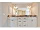 Bathroom featuring double vanity with granite countertops and storage at 6631 Se 11Th Loop, Ocala, FL 34472