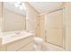 Bathroom with sliding shower door, toilet, and vanity sink at 6631 Se 11Th Loop, Ocala, FL 34472