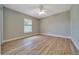 This bedroom has wood-look flooring and a ceiling fan, offering a comfortable and stylish space at 6631 Se 11Th Loop, Ocala, FL 34472