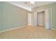 This bedroom features neutral tile flooring, and a closet that offers ample storage space at 6631 Se 11Th Loop, Ocala, FL 34472