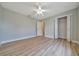 Bedroom with hardwood floors, ceiling fan, and closet at 6631 Se 11Th Loop, Ocala, FL 34472