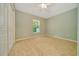This bedroom features neutral tile flooring, a window, and a closet at 6631 Se 11Th Loop, Ocala, FL 34472