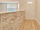 Charming entryway with modern stone accent wall and light hardwood floors at 6631 Se 11Th Loop, Ocala, FL 34472