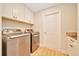 Convenient laundry room with modern washer, dryer, and ample storage space at 6631 Se 11Th Loop, Ocala, FL 34472