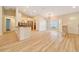 Open-concept living room and kitchen with sleek hardwood floors and ample natural light at 6631 Se 11Th Loop, Ocala, FL 34472
