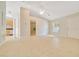 This living room features neutral tile flooring, a ceiling fan, and provides easy access to other rooms at 6631 Se 11Th Loop, Ocala, FL 34472