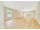 Bright and airy living room with multiple windows and wood-look flooring at 6631 Se 11Th Loop, Ocala, FL 34472