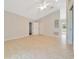 Neutral living room with tile floors provides access to backyard and other rooms at 6631 Se 11Th Loop, Ocala, FL 34472