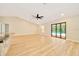 Open-concept living room with hardwood floors, ceiling fan, and view to the pool at 6631 Se 11Th Loop, Ocala, FL 34472