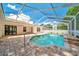 Inviting in-ground pool with a screened enclosure and paved deck, ideal for outdoor living at 6631 Se 11Th Loop, Ocala, FL 34472