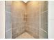 Shower featuring neutral tile and built in shelving at 6631 Se 11Th Loop, Ocala, FL 34472