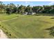 Expansive lawn surrounds a charming single-story home with a two-car garage, complemented by mature trees at 6730 Sw 9Th Ave, Ocala, FL 34476