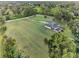 Home features a screened-in pool and is surrounded by expansive, lush lawn with mature trees at 6730 Sw 9Th Ave, Ocala, FL 34476
