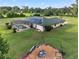 Aerial view of a private backyard with a screened pool, fire pit, and lush landscaping at 6730 Sw 9Th Ave, Ocala, FL 34476
