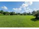 Expansive green backyard with clear blue skies at 6730 Sw 9Th Ave, Ocala, FL 34476