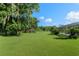 Expansive green backyard featuring a playground, mature trees, and pool area at 6730 Sw 9Th Ave, Ocala, FL 34476