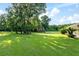 Treehouse and backyard with mature trees and well-maintained lawn near enclosed pool at 6730 Sw 9Th Ave, Ocala, FL 34476